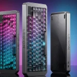 A photo showing three Lenovo Legion gaming keyboards stood up in a row. The first two face forward, with translucent keycaps displaying vibrant pink and blue RGB lighting effects. The third keyboard is turned to show its matte black textured back panel with concentric circle patterns and the 'LEGION' logo. The background features glowing pink and blue light.