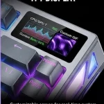 An extreme close-up photograph focusing on the top-right corner of a grey mechanical keyboard. It clearly shows the arrow keys, with 'PgUp' and 'Home' keycaps glowing pink. The key feature is a small, rectangular built-in TFT display screen. The screen is on, displaying a complex, animated purple, blue, and green custom GIF and graph. Text below the screen is clearly legible and reads: 'Customizable screen for real-time system monitoring (Temp, Battery, Mode), profile selection, and dynamic custom GIFs (max 30fps). Dynamic UI changes.'