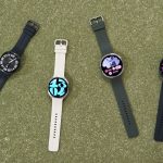 Four Samsung Galaxy Watch9 smartwatches arranged in a fan formation on a green surface.